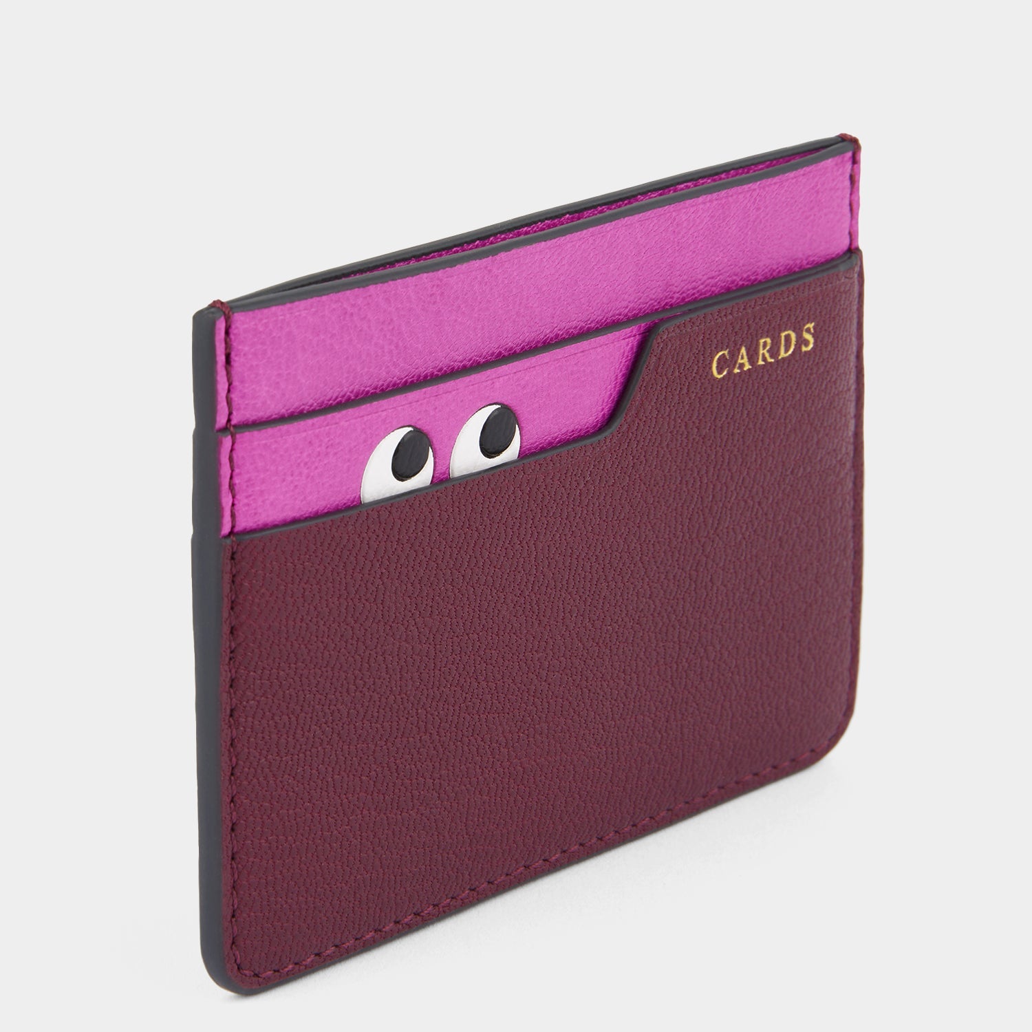 Purple card case with peeping eyes by Anya Hindmarch
