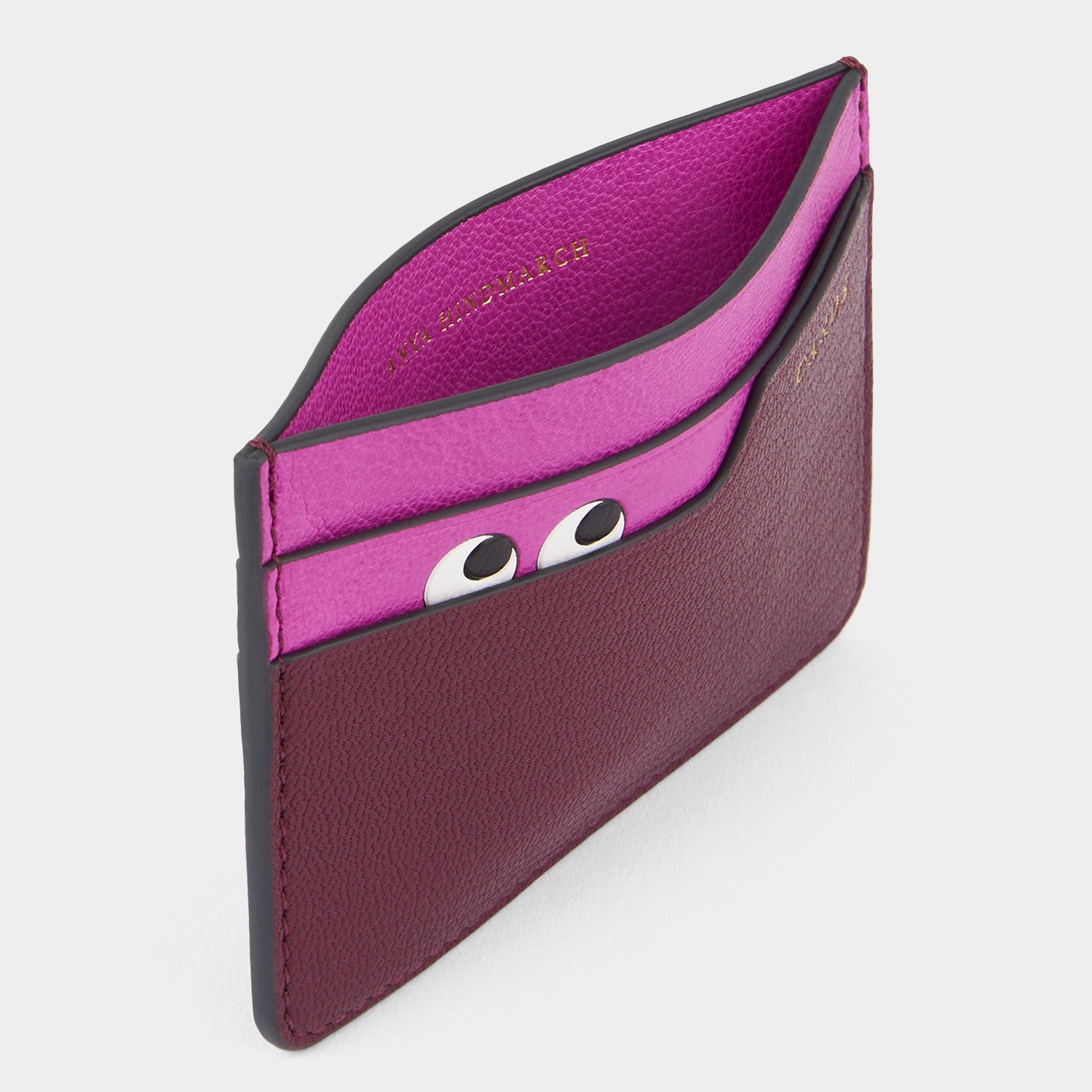 Purple card case with peeping eyes by Anya Hindmarch