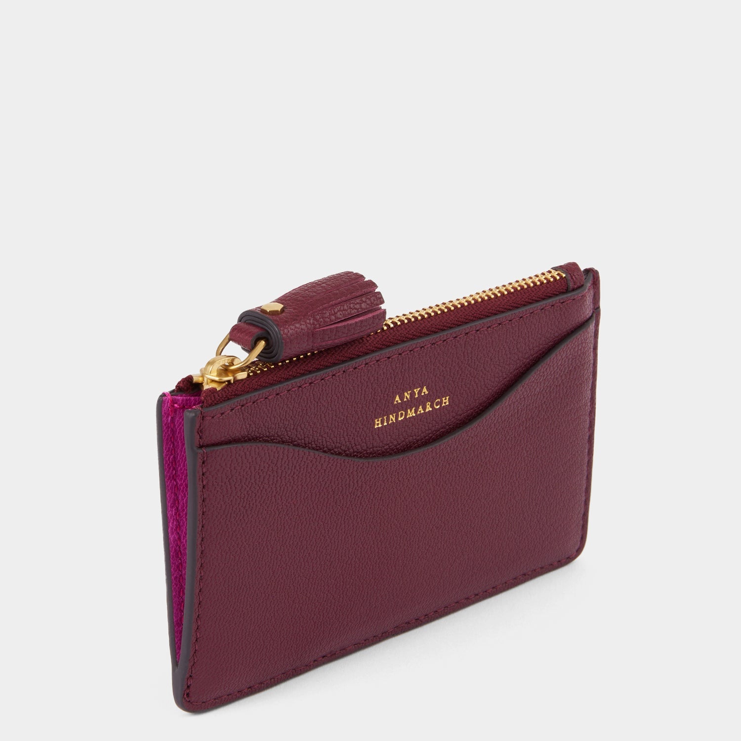 purple card holder with peeping eyes and tassled zip by Anya Hindmarch