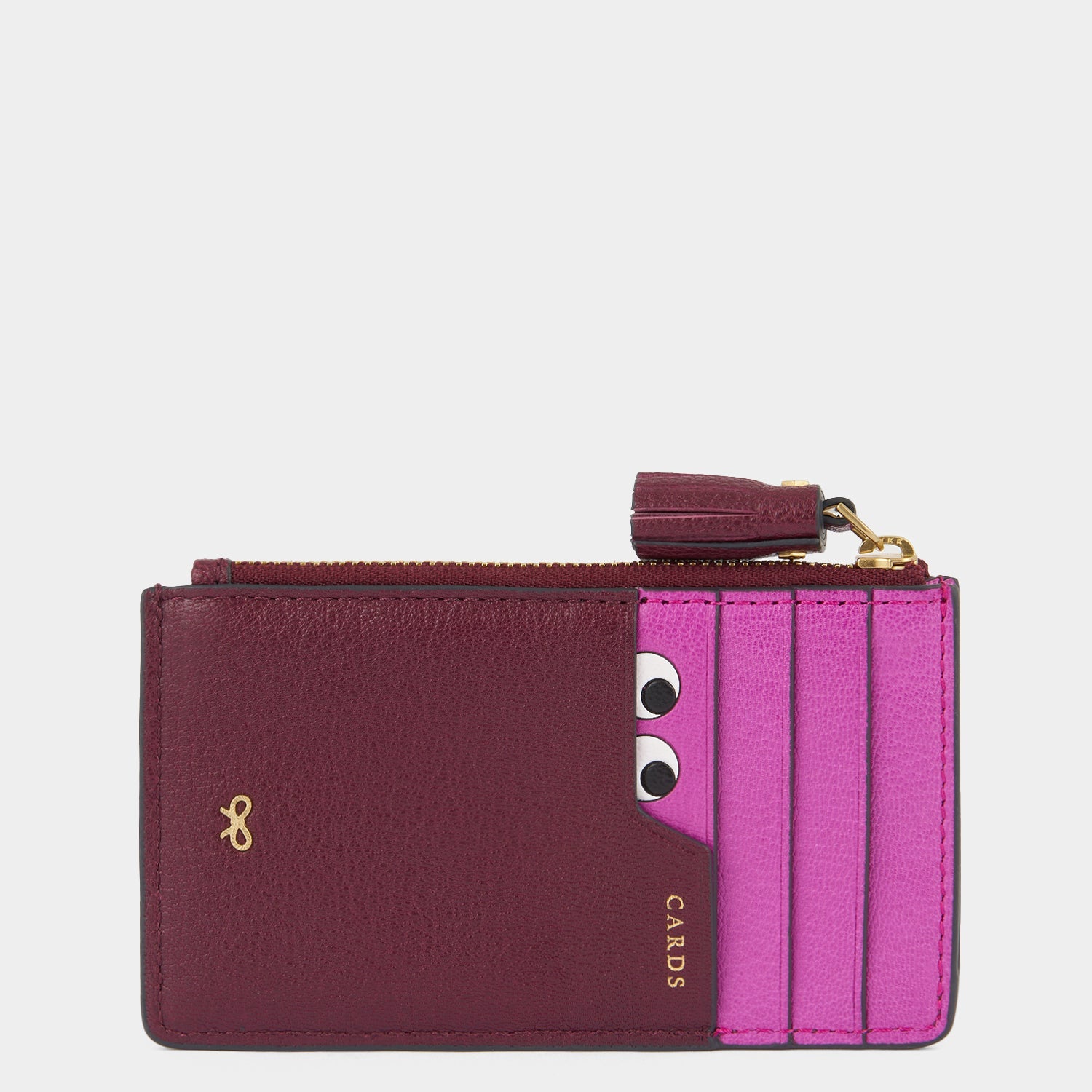 purple card holder with peeping eyes and tassled zip by Anya Hindmarch