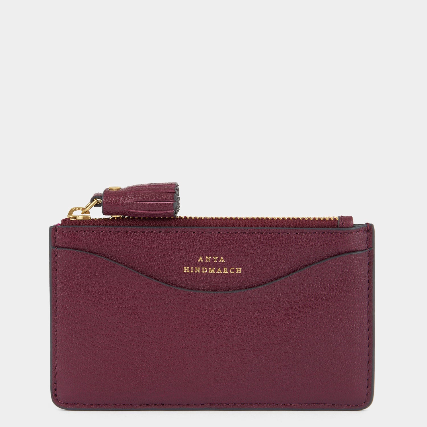 purple card holder with peeping eyes and tassled zip by Anya Hindmarch