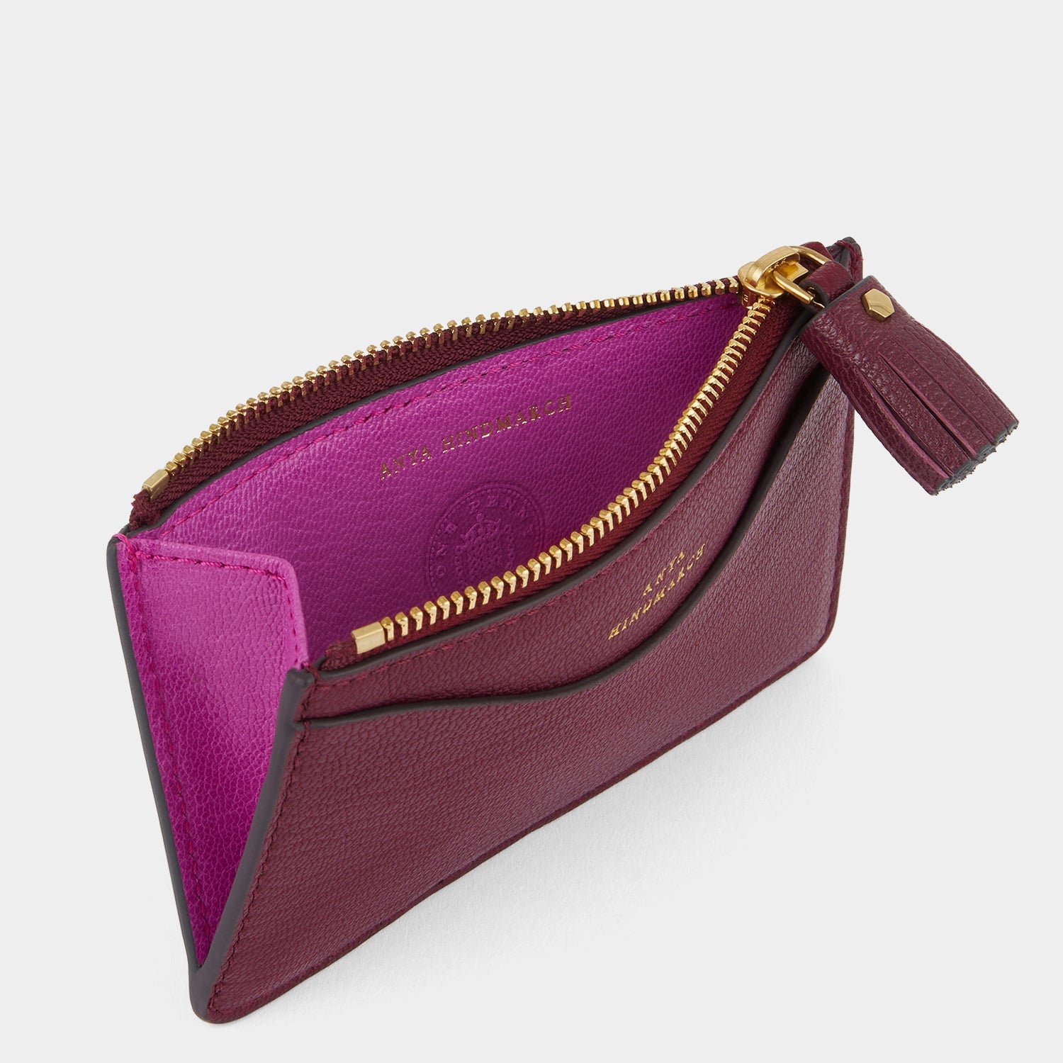 purple card holder with peeping eyes and tassled zip by Anya Hindmarch