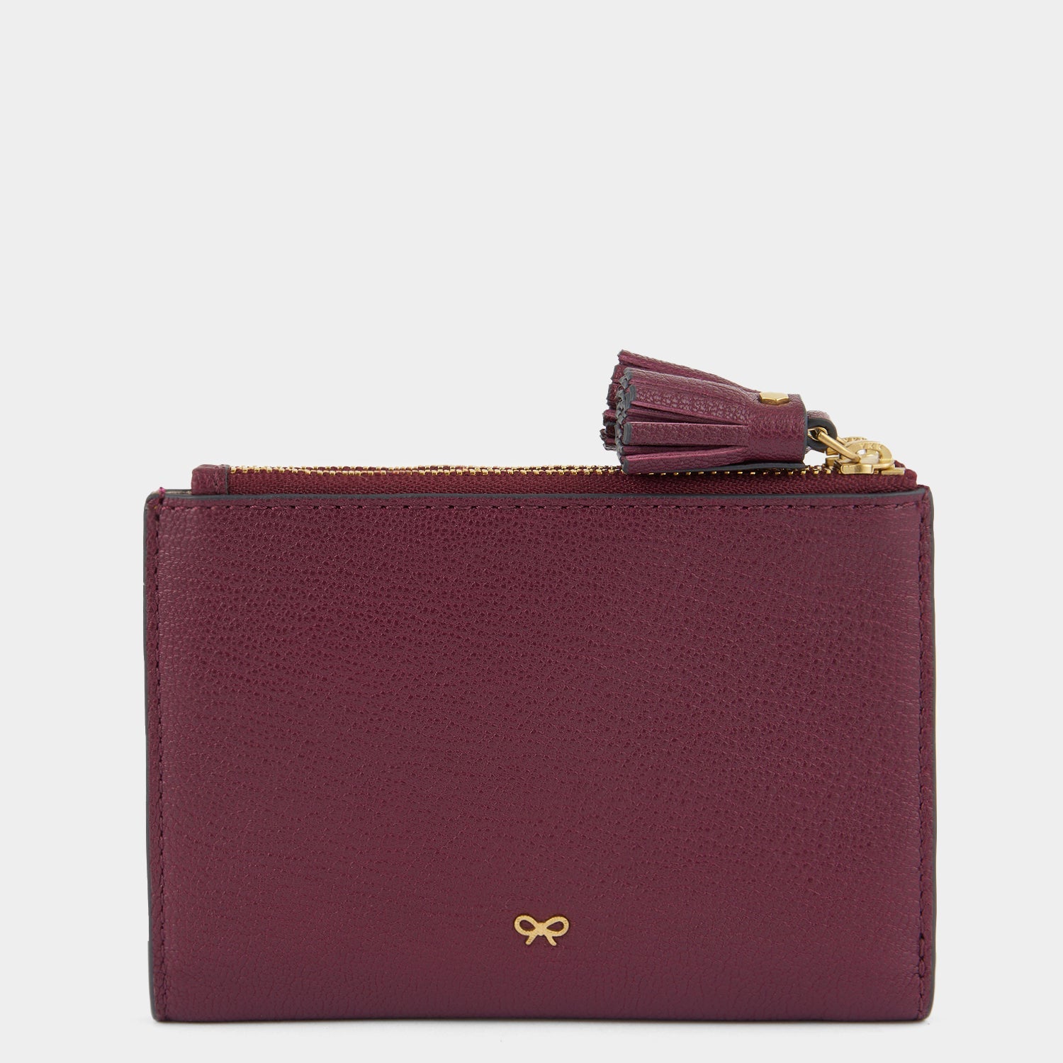Purple double zip wallet with peeping eyes by Anya Hindmarch
