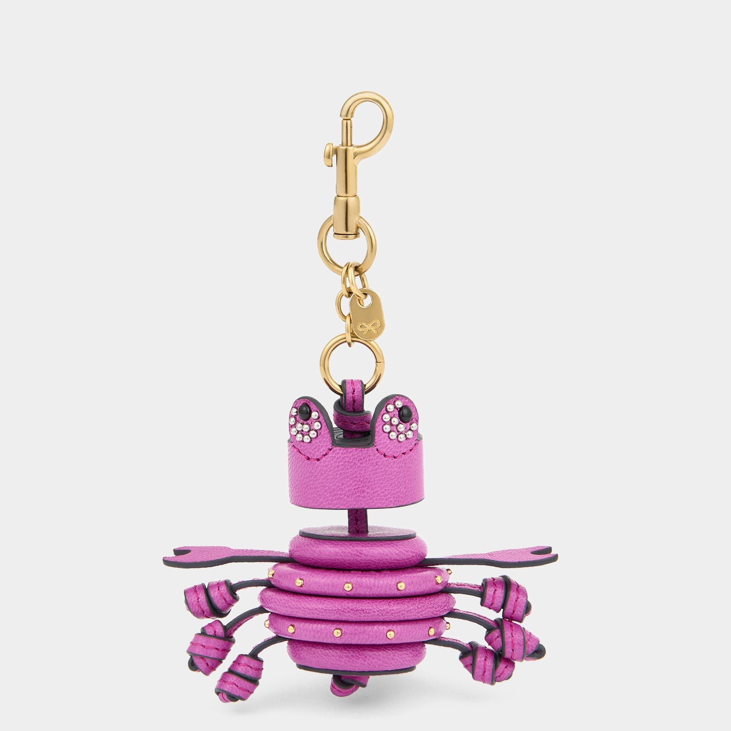 Crab charm handmade from bramble-pink capra leather and finished with fine stud embellishments by Anya Hindmarch